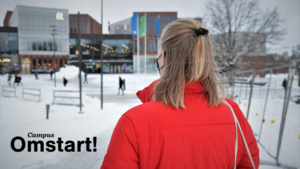 Student looking at the Aalto campus, CampusOmstart logo in the left corner