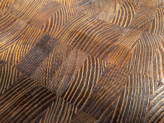 Closeup of wood grain surface coated in dark stain