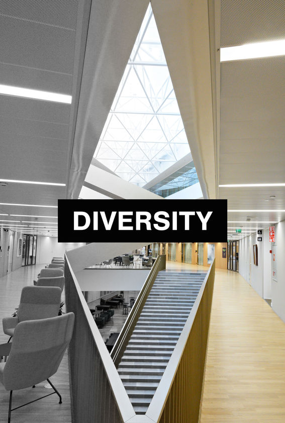 The picture is from the inside of the School of Business and it has the white text "diversity" in a black box in the middle. 