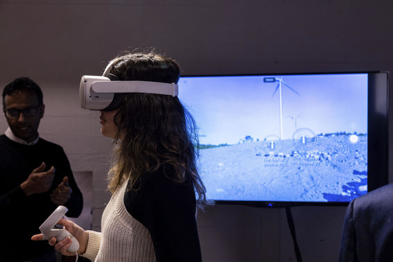 Visitor with VR glasses on in the Energy Futures exhibition at Dipoli Gallery.