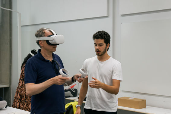 student giving instructions to a person trying a VR experience