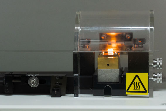 A device heats up a tiny glass tube.