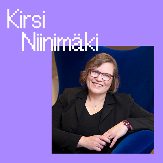 Professor Kirsi Niinimäki standing on a chair