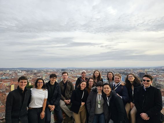 Unite! student representatives in Graz standing on a hill with the city in the background. 