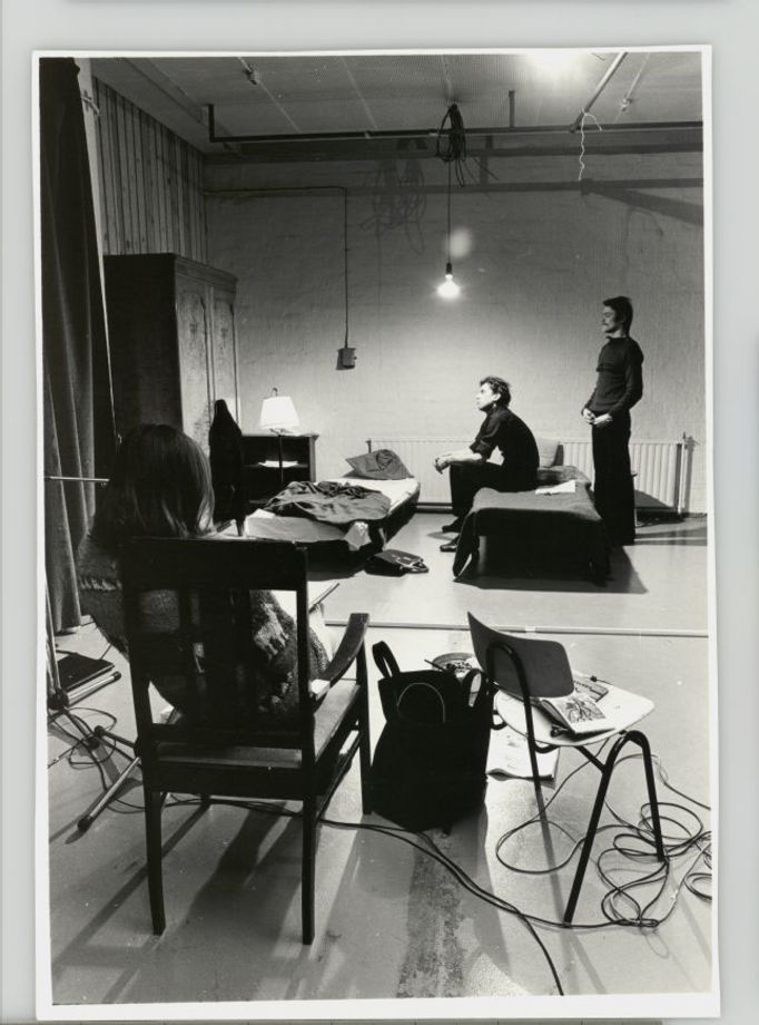 film set with bed in black and white with two men