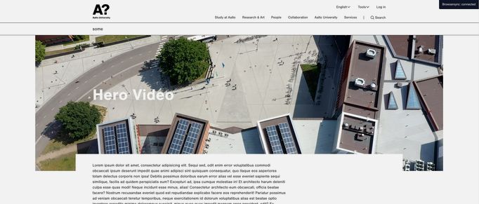 A still image of the new her video, showing the Otaniemi campus from above with a text box underneath