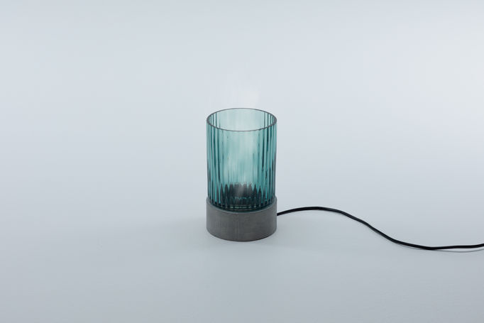 a turquoise coloured diffuser made of glass and concrete