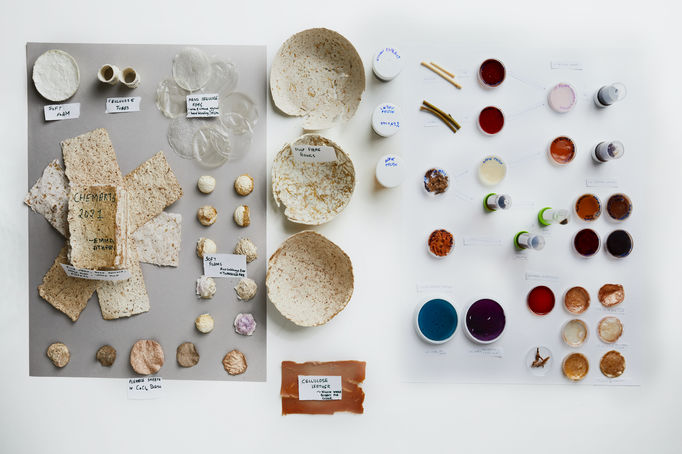 Portfolio photo of differentiations items produced by students Emma Sicher and Atharv Agarwal during the Aalto University Summer School course Nordic Biomaterials with CHEMARTS. The times are laid out on a white background and photographed from above. The times are beige coloured bowls made of pulp, a brown piece of cellulose leather and different kinds of foam and paper samples.