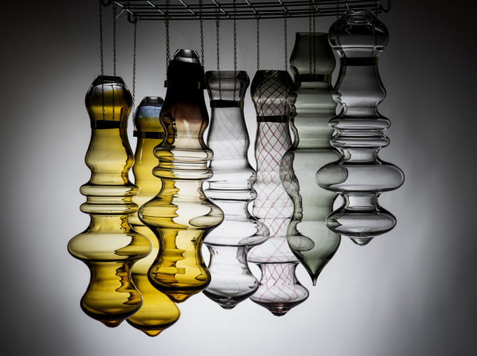 seven bubbly shaped glass objects hanging