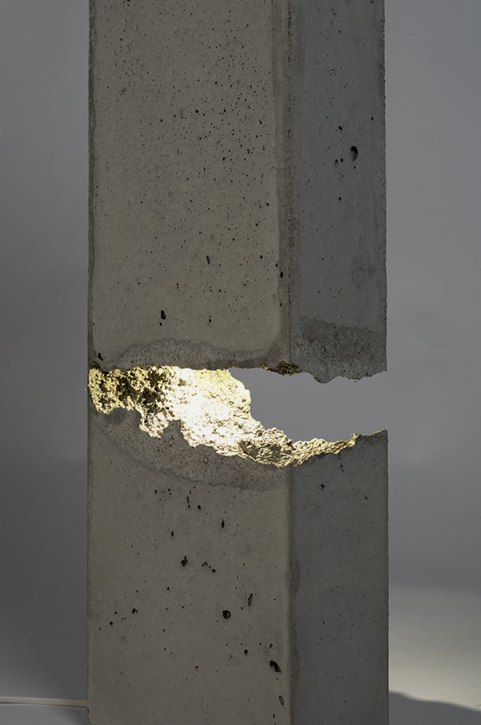 concrete lamp shaped like a pillar that has a crack of which the light comes out