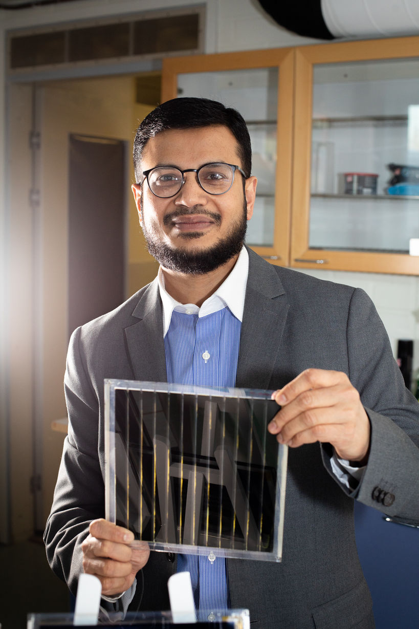 Dr Hashmi holding a printed solar panel