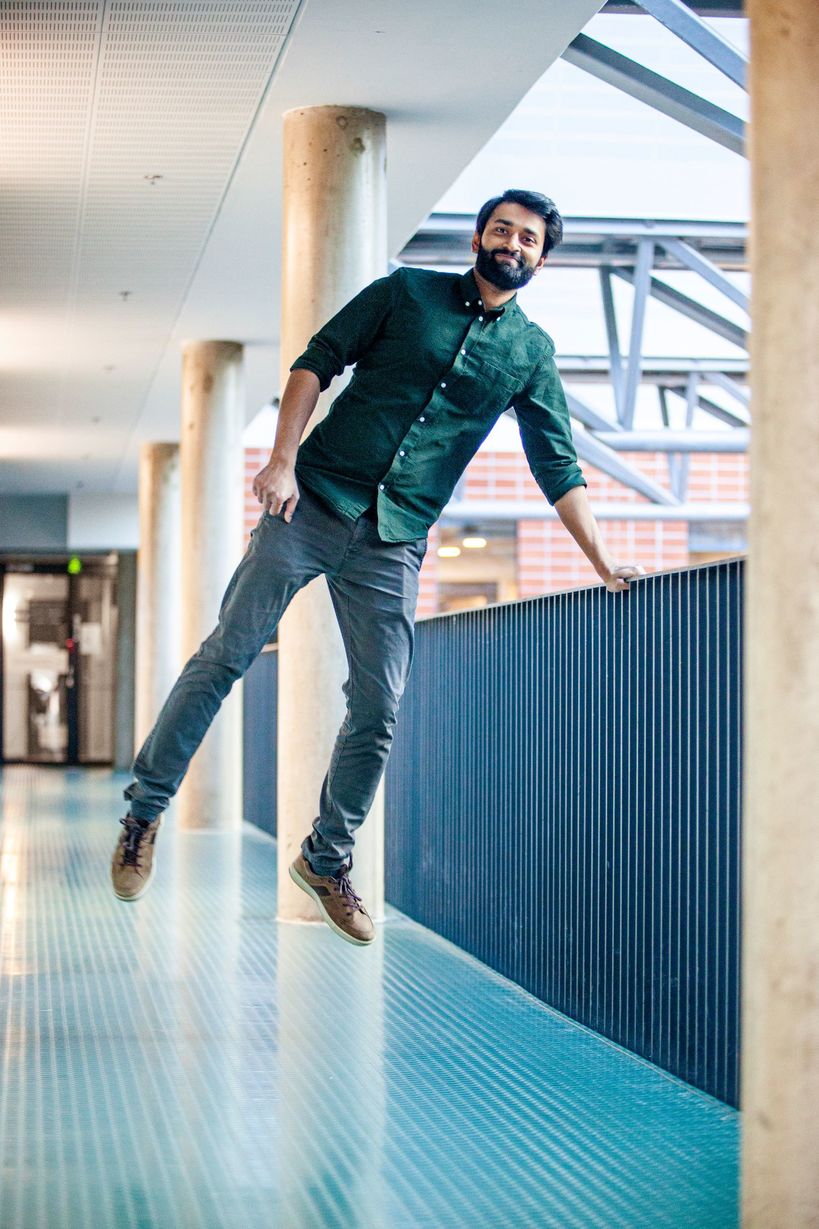 Researcher Ayush Bharti jumps in a hallway