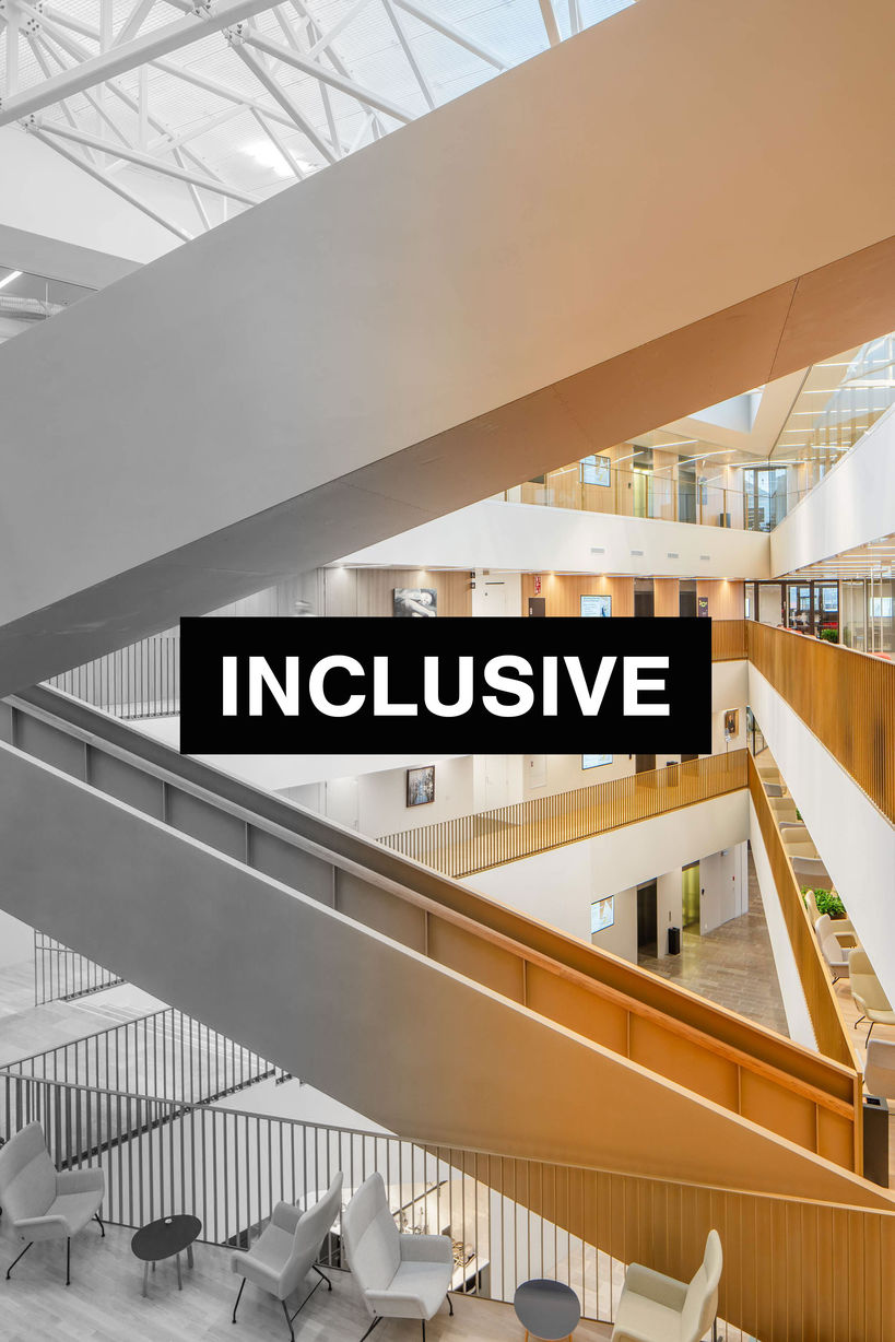 The photo is from the inside of the School of Business and it has the white text "inclusive" in a black box in the middle. 