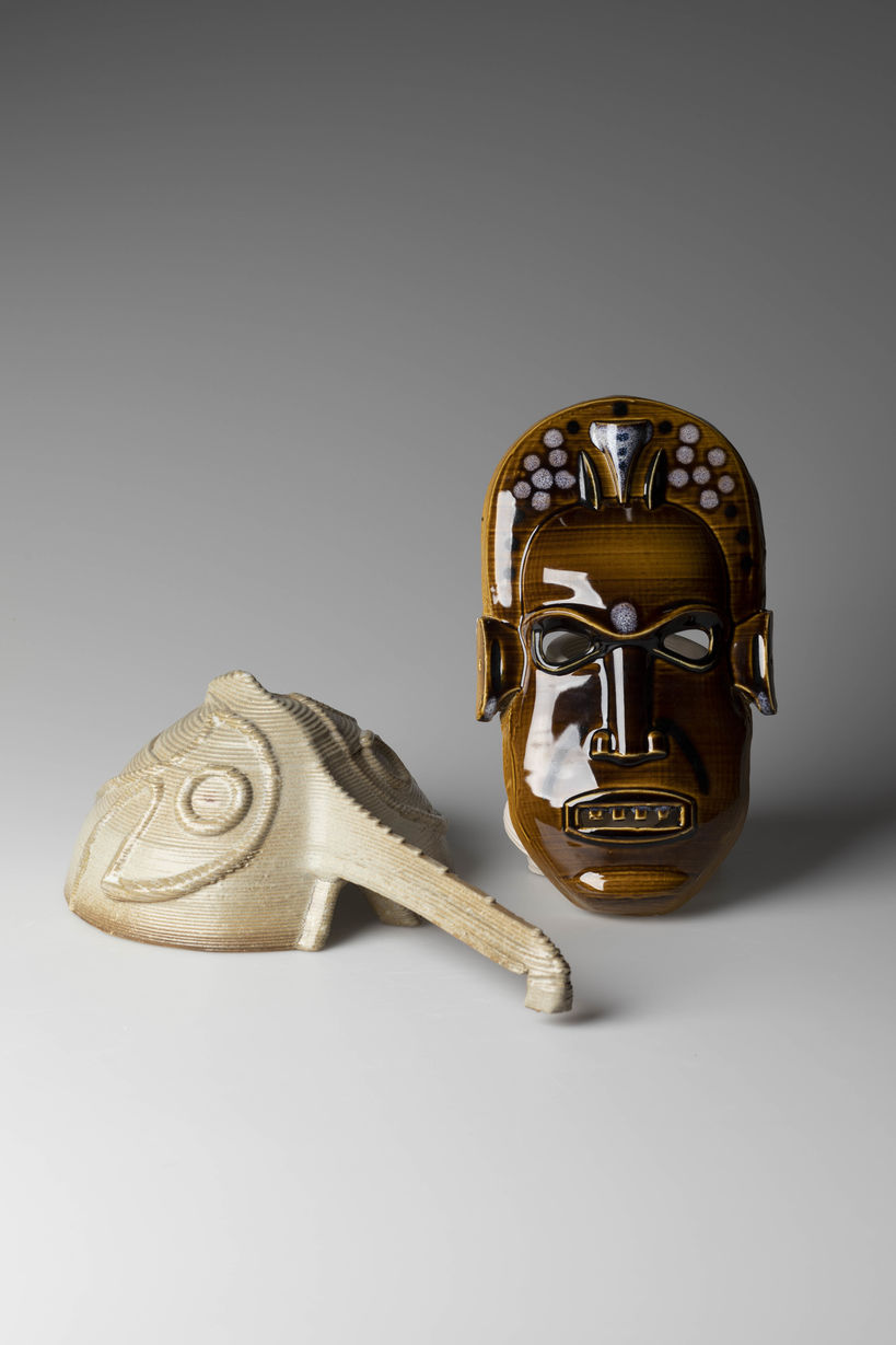 two ceramic sculptures representing kind of masks