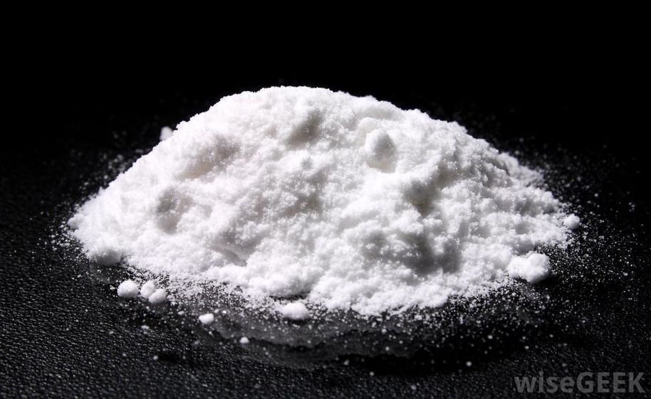 Microcrystalline cellulose white powder on black background