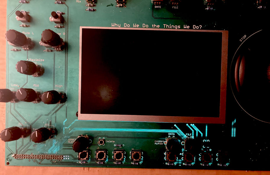A green audio board of circuits with black knobs and the sentence "Why do we do the things we do?" written in white font in capitals.
