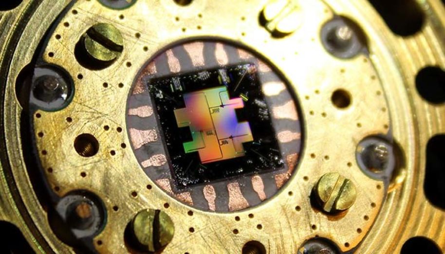 Photo of the centimeter-sized silicon chip which has three separate superconducting quantum bits. Photo: Jan Goetz/Aalto-yliopisto