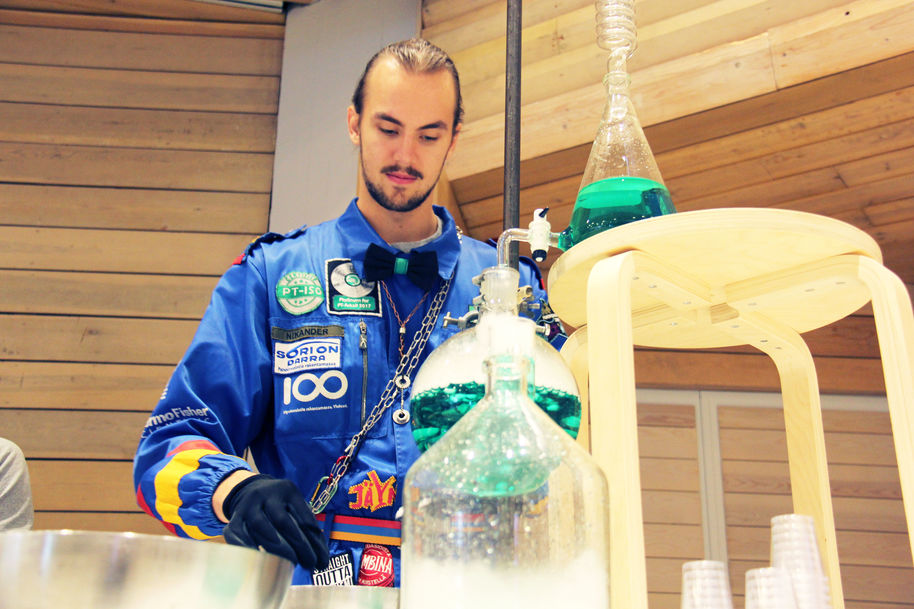An image of Rudolf with blue student overalls holding a green liquid