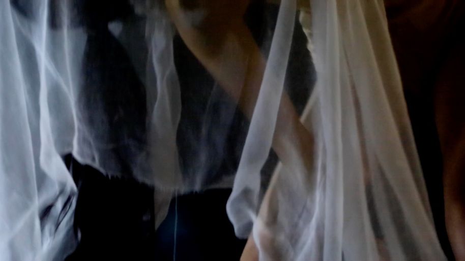 an abstract photo of a person tangled in fabrics