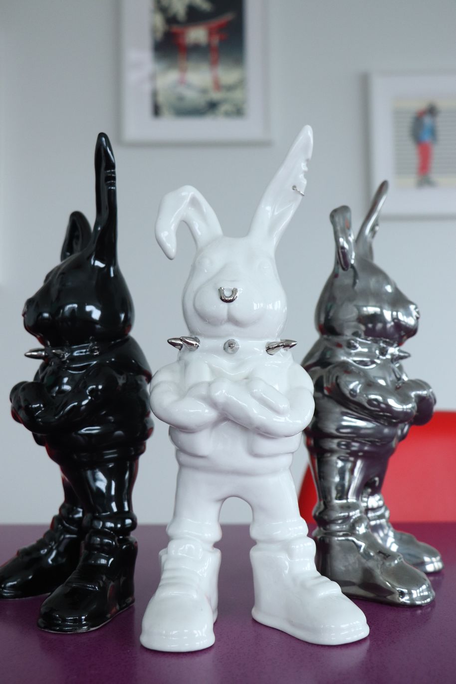 three ceramic bunnies standing on a table