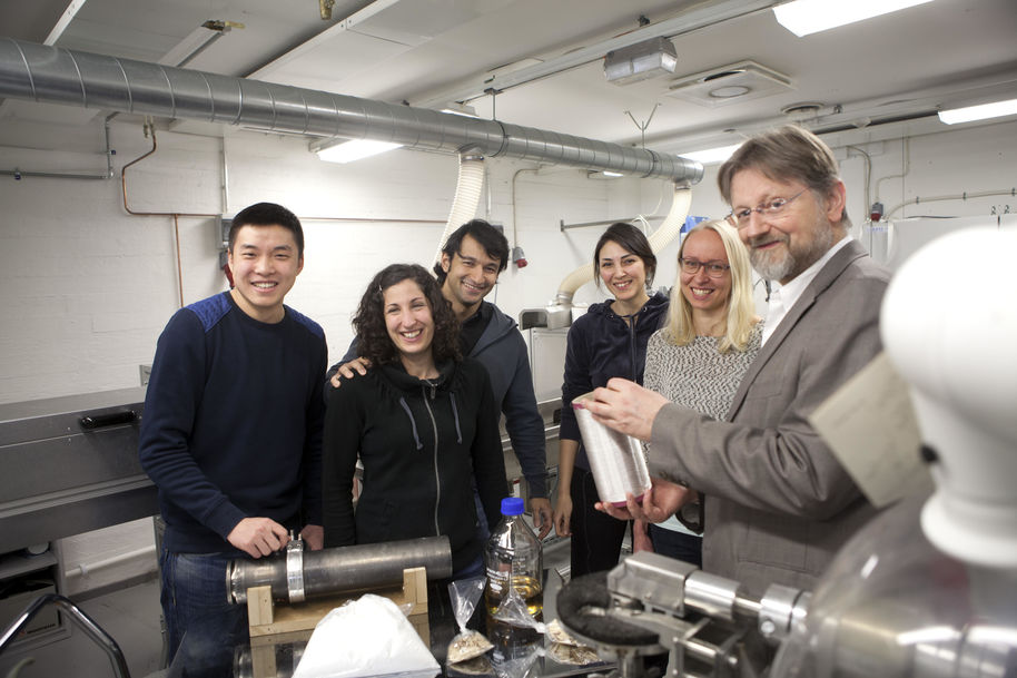 Professor Emeritus Herbert Sixta and members of the Ioncell team posing beside a Ioncell spinning machine