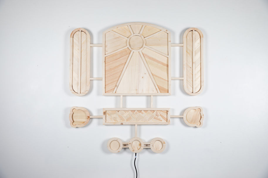 Symmetrical wood sculpture made of waste wood in geometric shapes and patterns