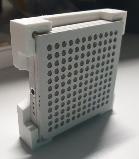 A device wiht holes in a plastic holder