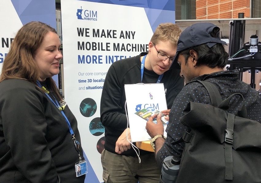 “Isabella Oksama and Aleksi Turunen of GIM Robotics discussing with an EIT Master student” Photo Credits: EIT Digital/Lea Myyryl