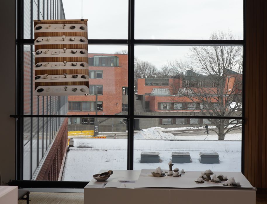 Clay objects topped with snow exhibited at Aalto University