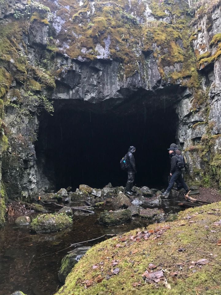 Students at the mouth of a cave in Black Mountain (Mustavuori in Finnish).