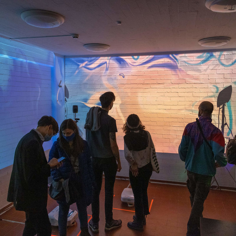 Students in front of the interactive digital mural in Space 21.