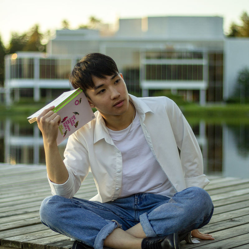 BScBA student Khai sitting by the lake